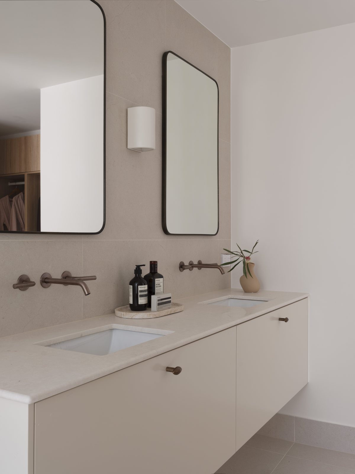 Floating double vanity with twin mirrors and a stone benchtop in a Gold Coast ensuite renovation
