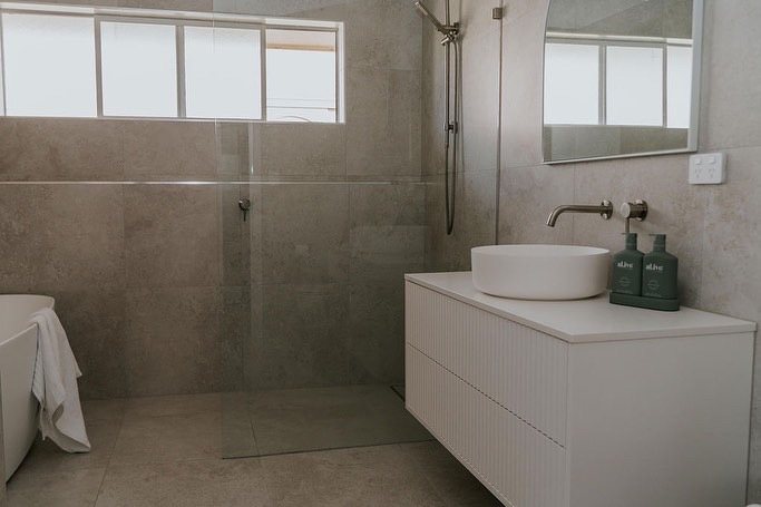 Floating vanity beside a tiled shower in a Gold Coast bathroom renovation