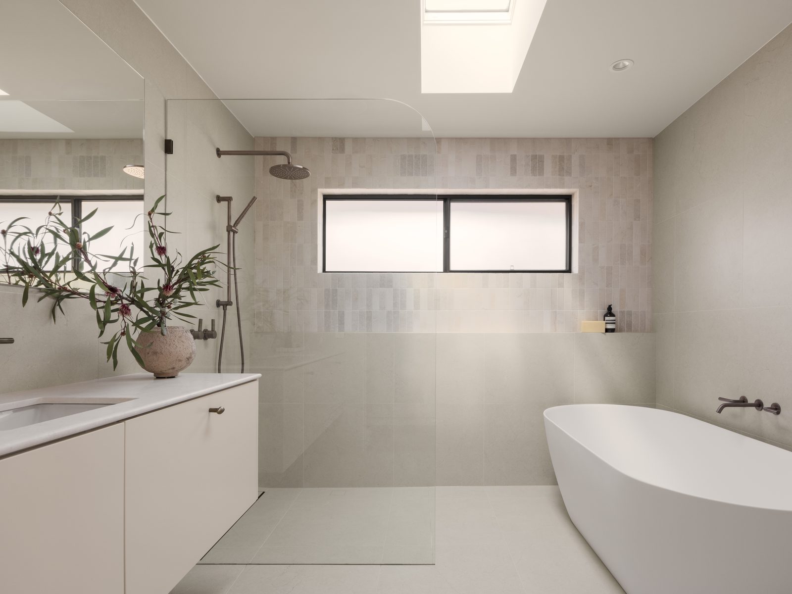 Renovated Gold Coast bathroom with a walk-in shower, floating vanity and freestanding bath