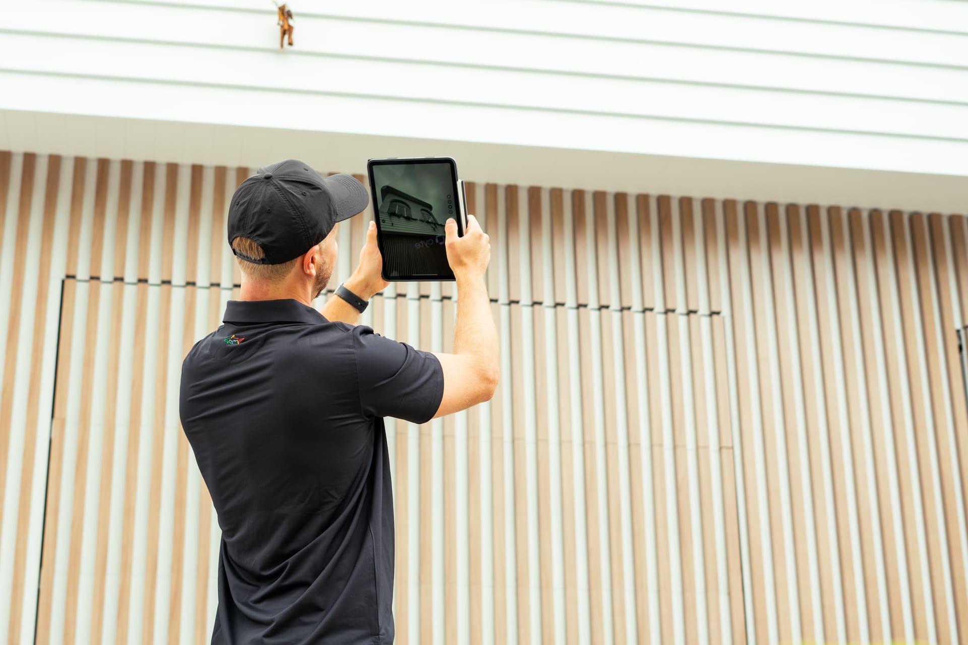 Inspector photographing the top of a residential property