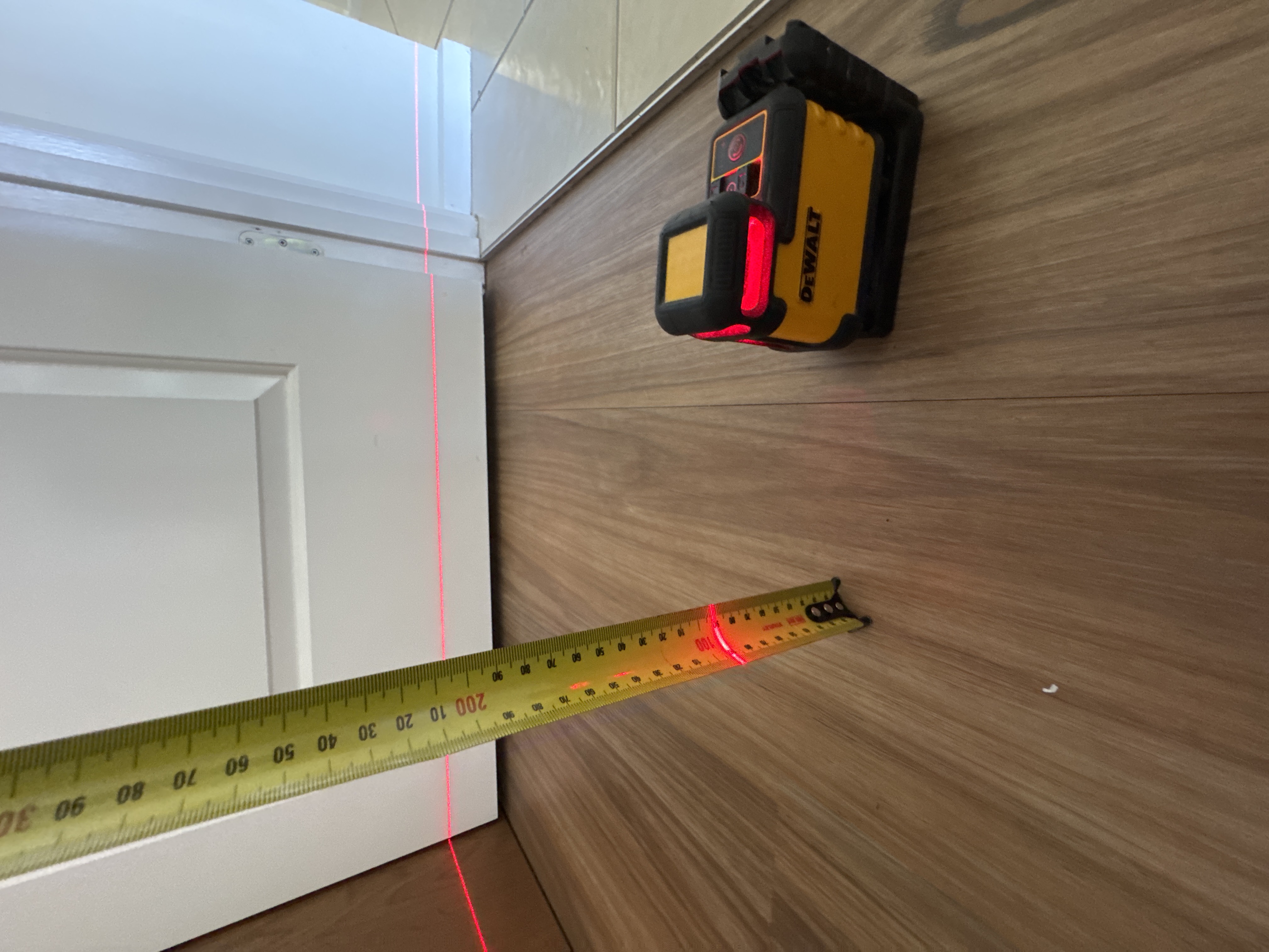 CYTE inspector's digital laser level used to check floor levels during a Gold Coast building and pest inspection — sagging or out-of-level floors can be one visible sign of termite or structural damage